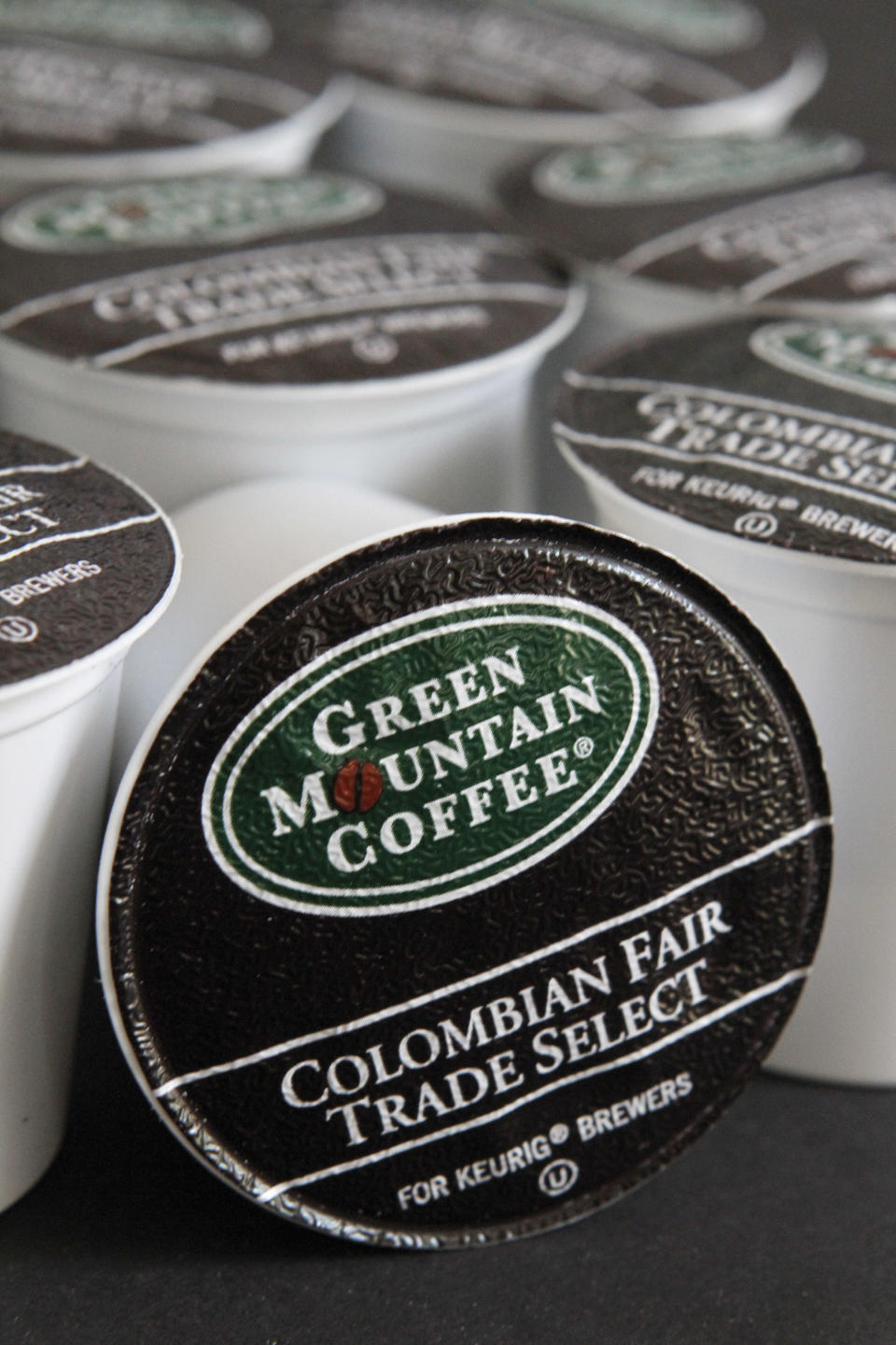 Colombian Fair Trade coffee by Green Mountain Coffee Roasters is displayed for a photograph in Montpelier, Vt., On Monday, May 21, 2012. Two New England specialty coffee companies and leaders in the fair trade movement are squaring off over what one says is a slackening of standards by an agency that certifies companies as good corporate citizens. (AP Photo/Toby Talbot)