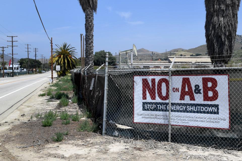 Signs opposing the oil measures are posted at Aera Energy's facility in the Ventura area.