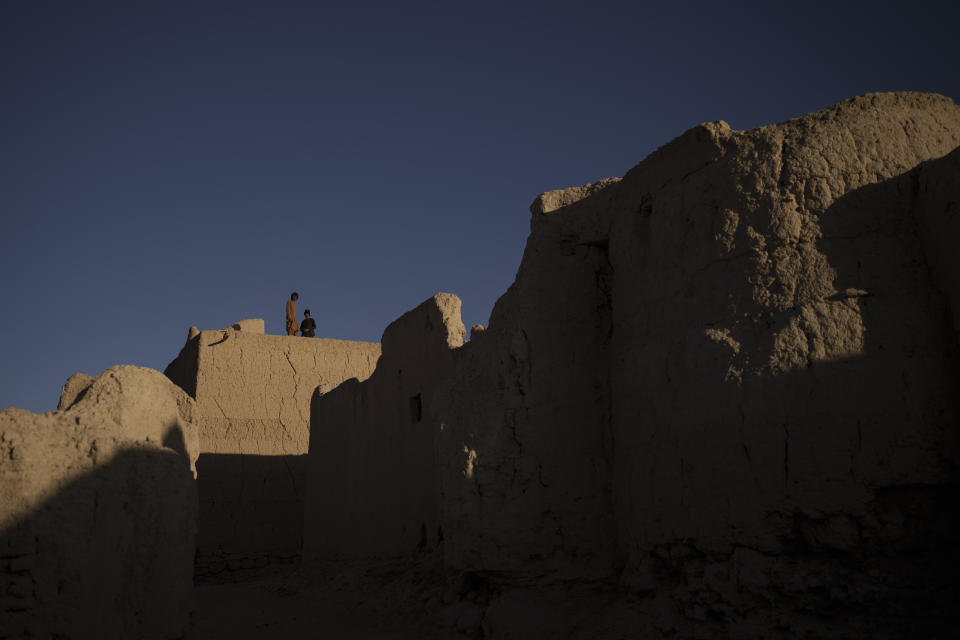 Afghans stand on the rooftop of their home in Salar village, Wardak province, Afghanistan, Tuesday, Oct. 12, 2021. In urban centers, public discontent toward the Taliban is focused on threats to personal freedoms, including the rights of women. In Salar, these barely resonate. The ideological gap between the Taliban leadership and the rural conservative community is not wide. Many villagers supported the insurgency and celebrated the Aug. 15 fall of Kabul which consolidated Taliban control across the country. (AP Photo/Felipe Dana)