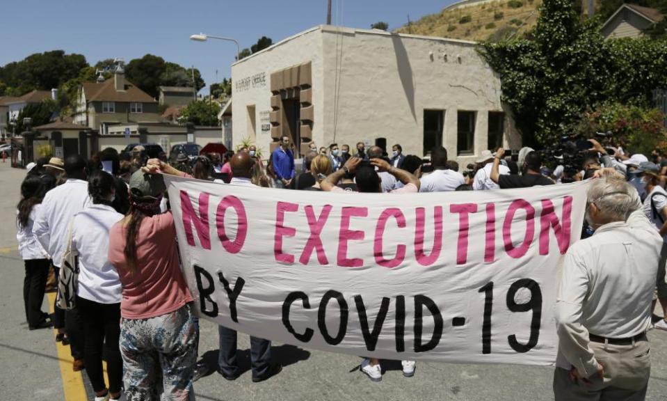 People hold up a banner at a news conference outside San Quentin state prison, 9 July 2020.