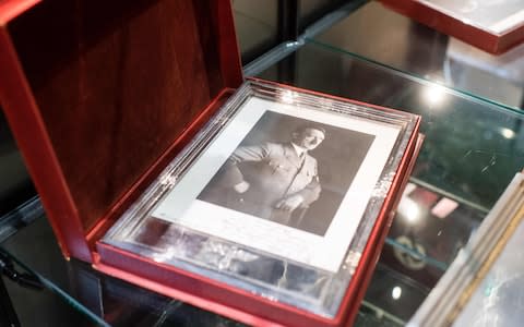 A framed portrait of Adolf Hitler is pictured on November 20, 2019 at the Â«Hermann HistoricaÂ» auction house in Grasbrunn near Munich, southern Germany, prior to an auction of personal belongings from German dictator Adolf Hitler and other notorious World War II Nazi leaders. - An auction of Nazi memorabilia, including Adolf Hitler's top hat, raked in hundreds of thousands of euros in Munich Wednesday, November 20, 2019, in the teeth of German and international protest. The hammer fell on the Nazi leader's top hat at 50,000 euros ($55,310), according to the Hermann Historica auction house website, while items of clothing belonging to his partner Eva Braun each sold for thousands. (Photo by Matthias Balk / dpa / AFP) / Germany OUT (Photo by MATTHIAS BALK/dpa/AFP via Getty Images) - Credit: MATTHIAS BALK/DPA