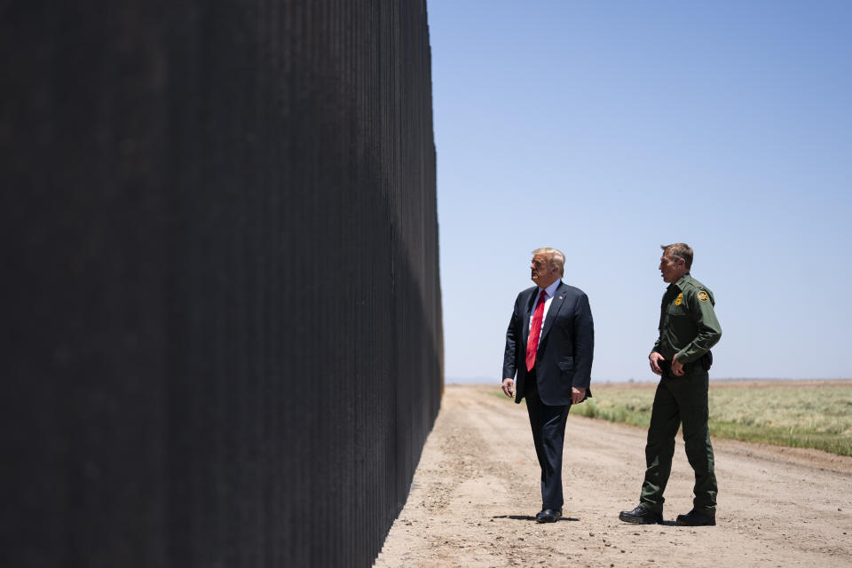 United State Border Patrol chief Rodney Scott gives President Donald Trump a tour of a section of the border wall, Tuesday, June 23, 2020, in San Luis, Ariz. The American Civil Liberties Union is making plans to fight the immigrant raids and mass deportations that former President Donald Trump has promised if he were to win a second term. (AP Photo/Evan Vucci)