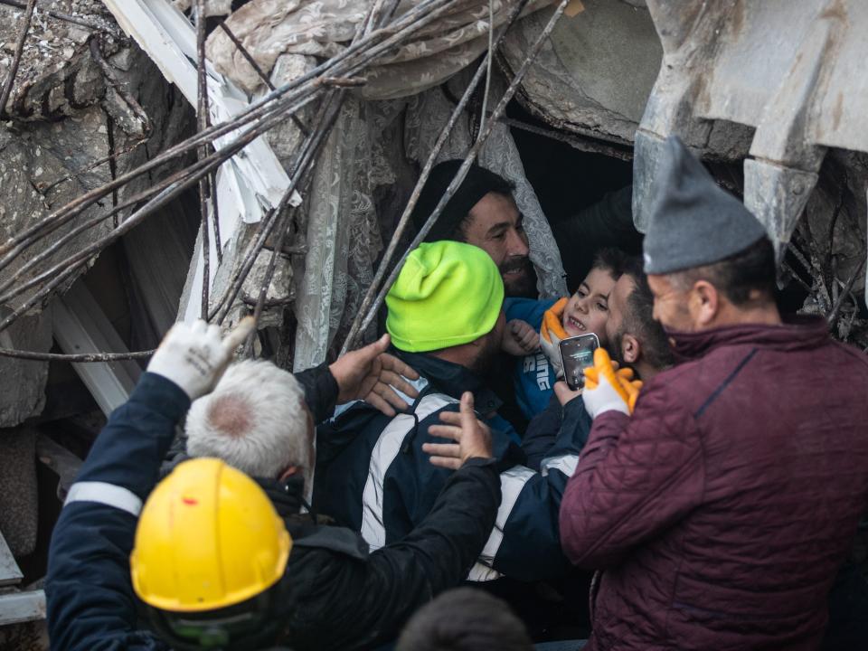 Rescue workers carry Yigit Cakmak, 8-years-old survivor at the site of a collapsed building 52 hours after the earthquake struck, on February 08, 2023 in Hatay, Turkey. A 7.8-magnitude earthquake hit near Gaziantep, Turkey, in the early hours of Monday, followed by another 7.5-magnitude tremor just after midday