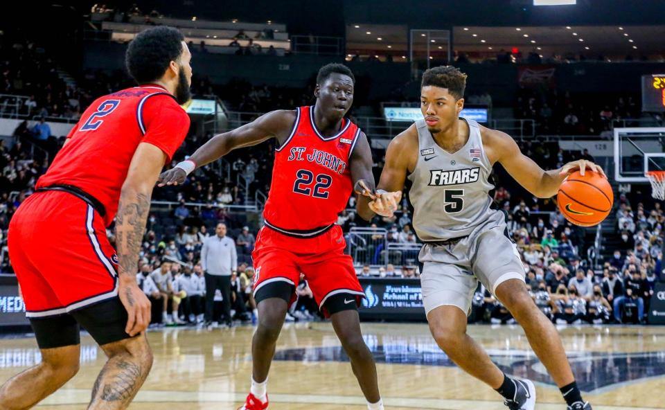 PC's Ed Croswell tries to get past a couple of St. John's players during their game in Jan. 8, the Friars last because COVID caused the team to stop playing.