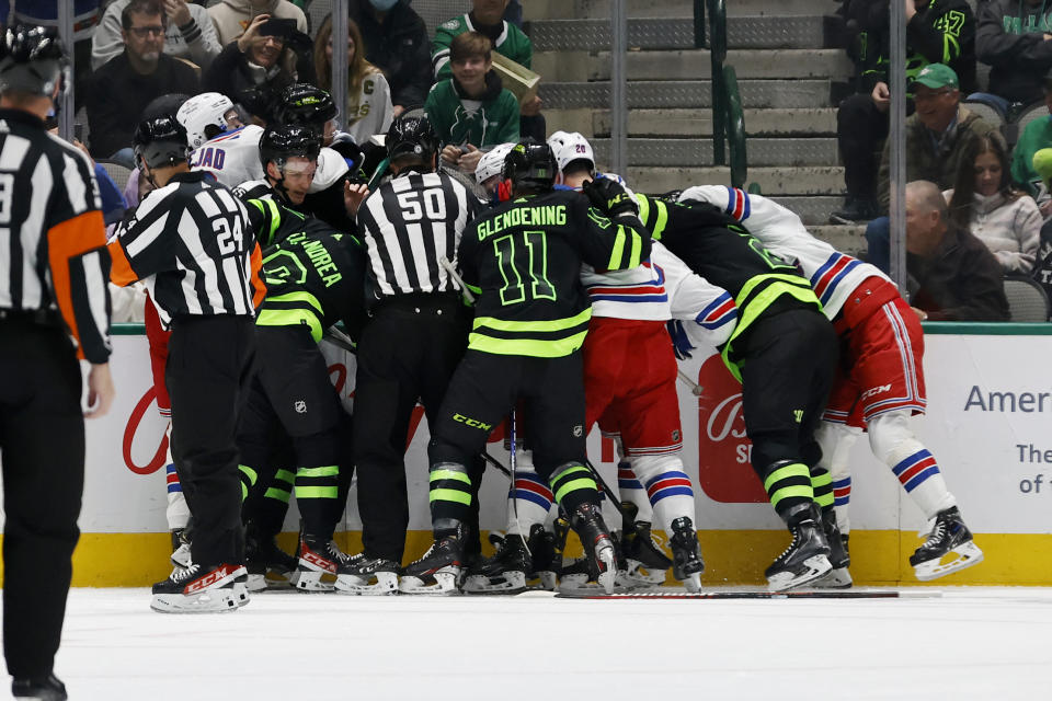 Dallas Stars and New York Rangers players fight after a penalty during the first period of an NHL hockey game in Dallas, Saturday, Oct. 29, 2022. (AP Photo/Michael Ainsworth)