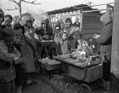 FILE - In this Feb 8, 1946, file photo, Japanese women are reduced to exchanging their personal belongings for goods from the street stand in Manchuria, China. They are waiting to return to Japan. At the end of the World War II, about 400,000 Japanese, including families of Imperial Army soldiers, Manchurian railway employees and farmers who had emigrated were in northern China, where Japan established a wartime puppet state.(AP Photo/File)