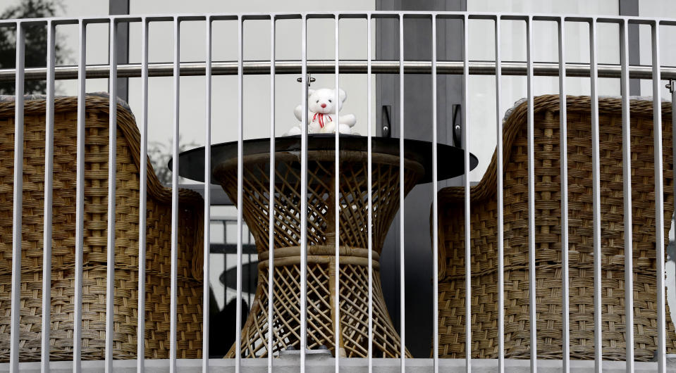 In this Sunday, March 29, 2020, photo, a teddy bear sits on the balcony of a house in Christchurch, New Zealand. New Zealanders are embracing an international movement in which people are placing teddy bears in their windows during coronavirus lockdowns to brighten the mood and give children a game to play by spotting the bears in their neighborhoods. (AP Photo/Mark Baker)