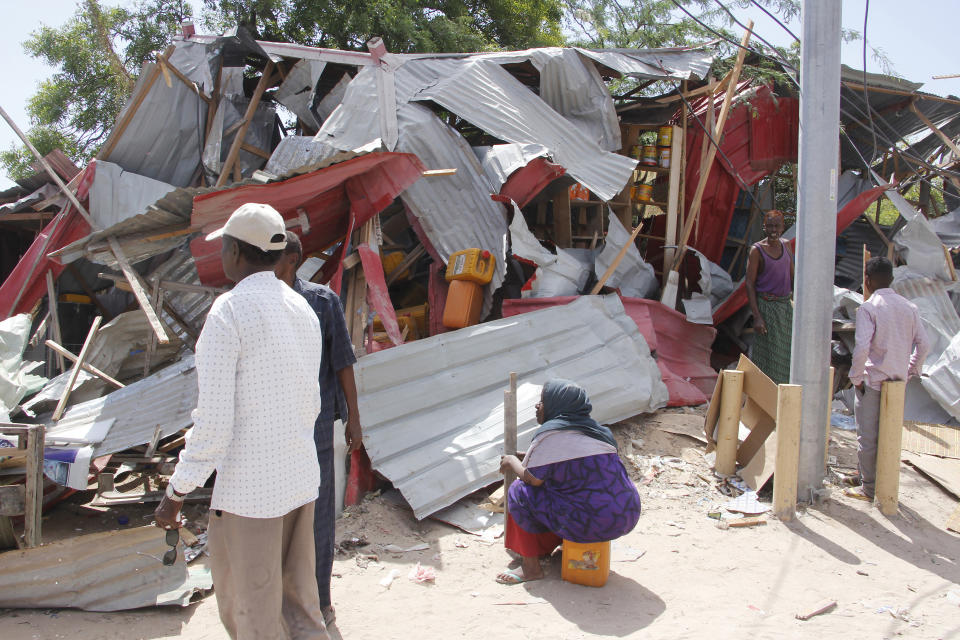 Somalis salvage goods after shops were destroyed in a car bomb in Mogadishu, Somalia, Saturday, Dec. 28, 2019. A truck bomb exploded at a busy security checkpoint in Somalia's capital Saturday morning, authorities said. It was one of the deadliest attacks in Mogadishu in recent memory. (AP Photo/Farah Abdi Warsame)