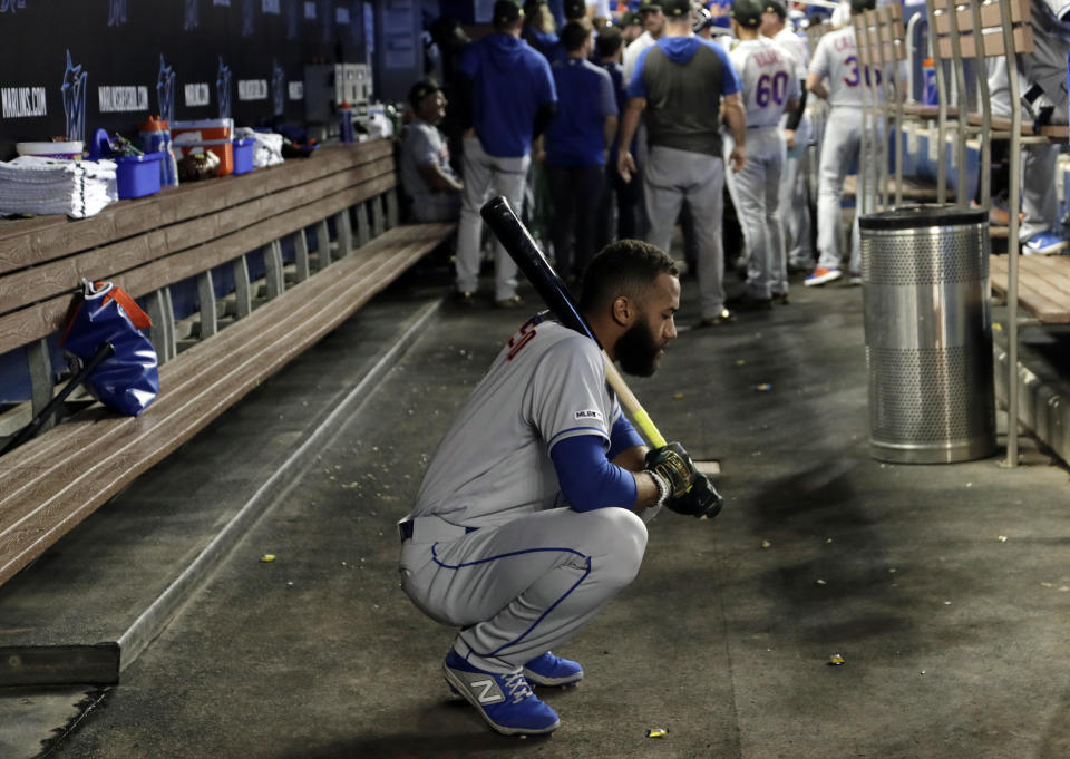 New York Mets shortstop Amed Rosario holds a bat in the dugout before a baseball game against the Miami Marlins, Saturday, May 18, 2019, in Miami. The Marlins won 2-0. (AP Photo/Lynne Sladky)