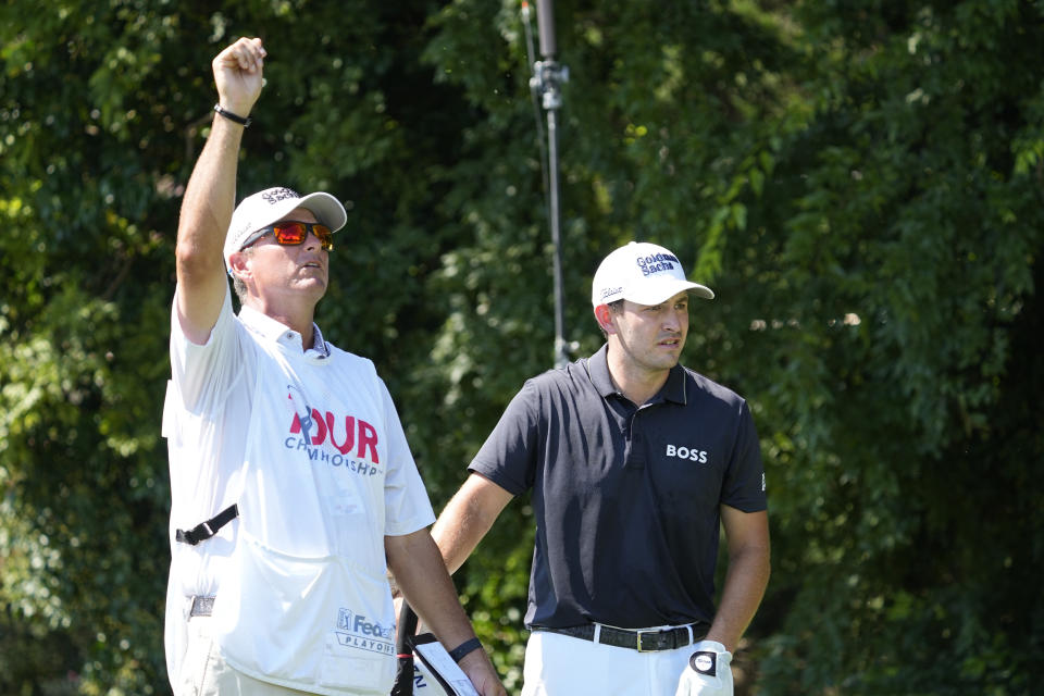 Patrick Cantlay and his caddie look over the conditions on the second tee during the third round of the Tour Championship golf tournament at East Lake Golf Club Saturday, Aug. 27, 2022, in Atlanta. (AP Photo/Steve Helber)