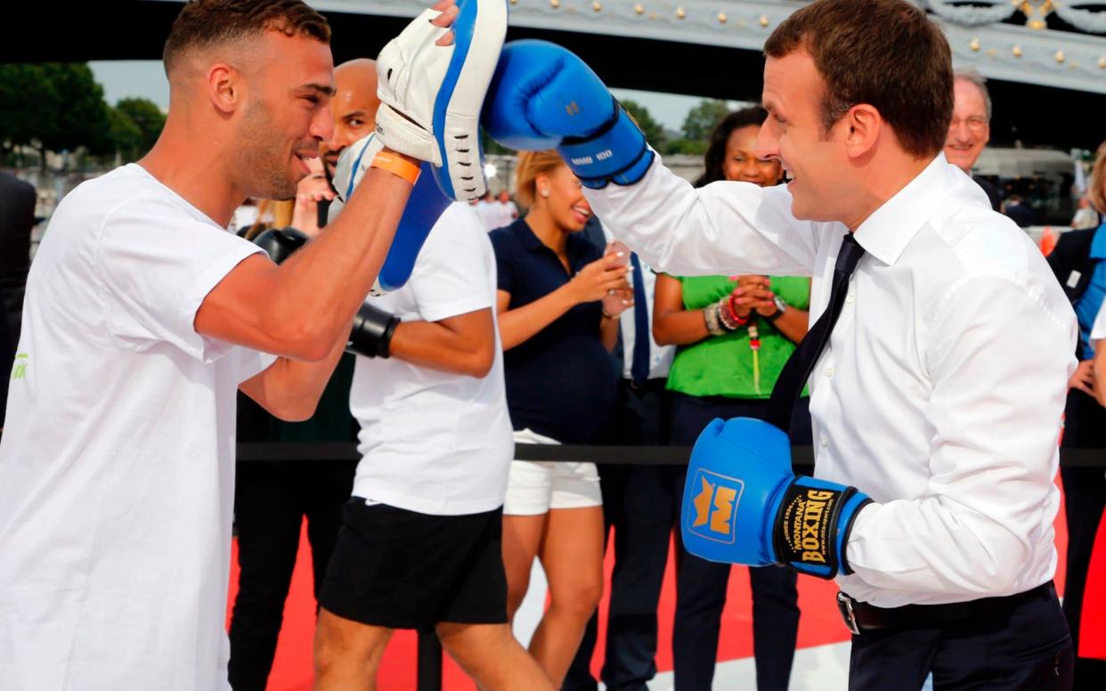 Fighting spirit: Emmanuel Macron spars with a boxing partner in Paris on June 24, 2017, at an event to promote the city's bid to host the 2024 Olympic and Paralympic Games - AFP