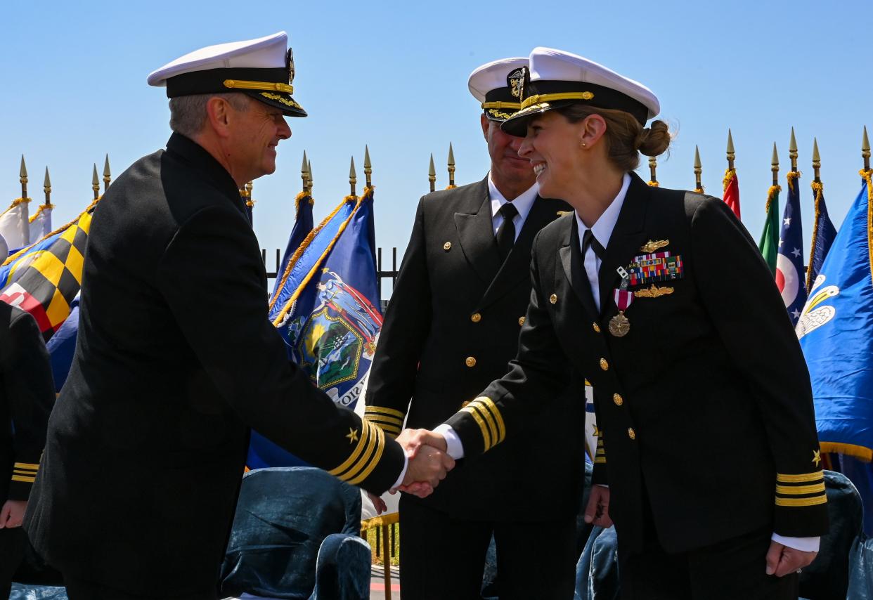 Navy Cmdr. Taylor Forester shakes hands with Cmdr. Blythe Blakistone as he relieves her during a change of command ceremony for Naval Special Warfare Tactical Communications Command April 28.