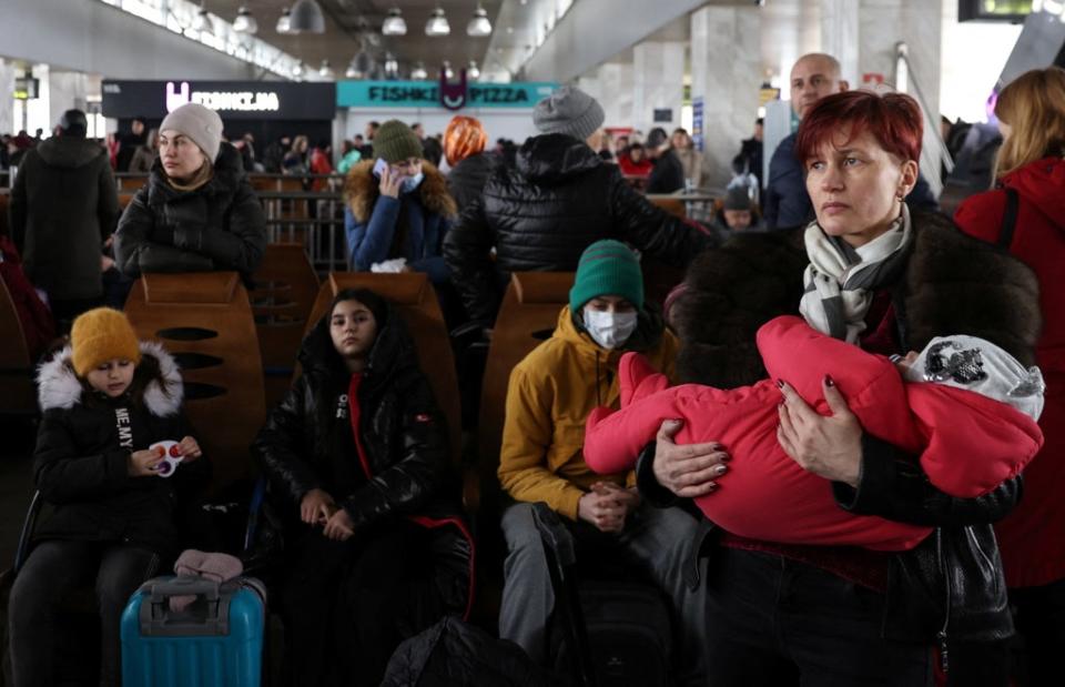 People wait to board an evacuation train from Kyiv to Lviv at Kyiv central train station following Russia's invasion of Ukraine (Reuters)