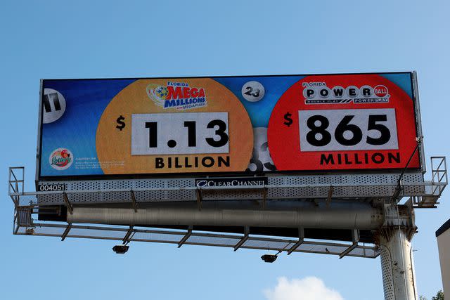 <p>Joe Raedle/Getty</p> A billboard showing the Mega Millions amount in Miami, Florida.