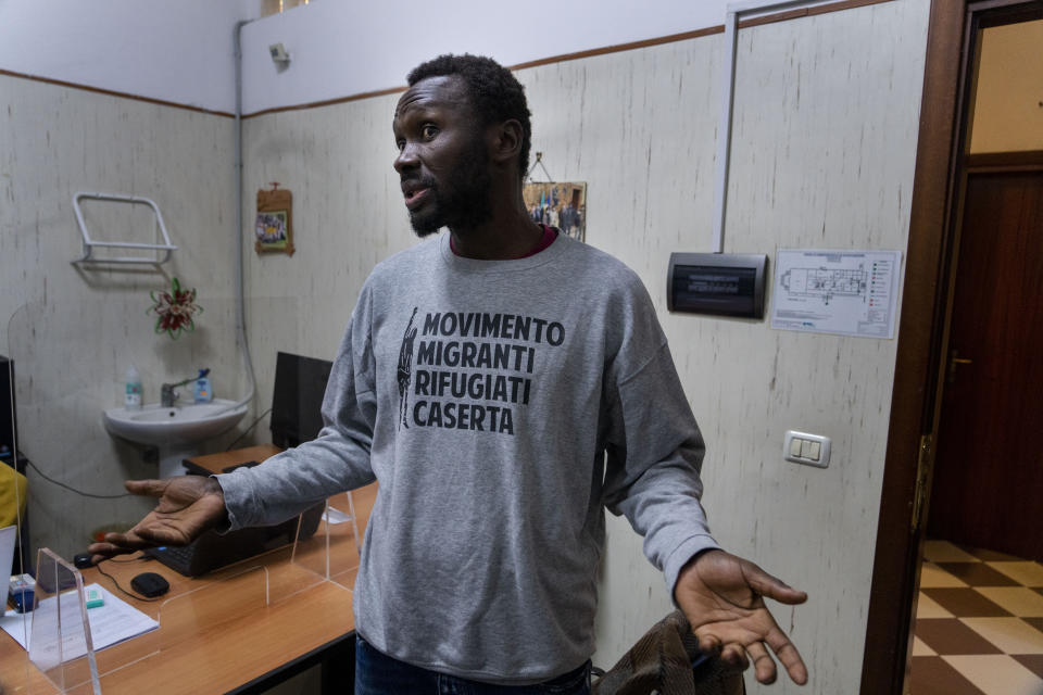 Mamadou Kouassi, left, a migrant who made the journey from his native Ivory Coast to Italy in 2006, talks to The Associated Press during an interview in a migrant center in Castel Volturno, southern Italy, where he now dedicates his life to working with migrants, Thursday, Feb. 1, 2024. Kouassi's odyssey through Africa inspired the movie Io Capitano (Me Captain) to Italian director Matteo Garrone and is among the nominees for the 2024 96th Academy Awards in the International Feature Film category. (AP Photo/Domenico Stinellis)