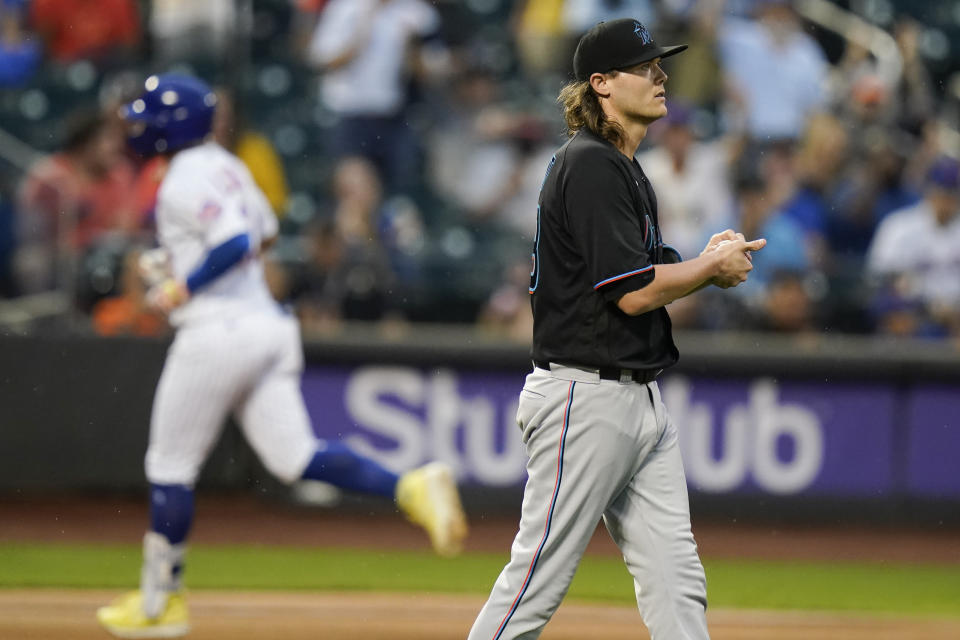 Miami Marlins relief pitcher Steven Okert, right, reacts as New York Mets' Francisco Lindor (12) runs the bases after hitting a two-run home run during the sixth inning in the first baseball game of a doubleheader Tuesday, Sept. 28, 2021, in New York. The Mets won 5-2. (AP Photo/Frank Franklin II)