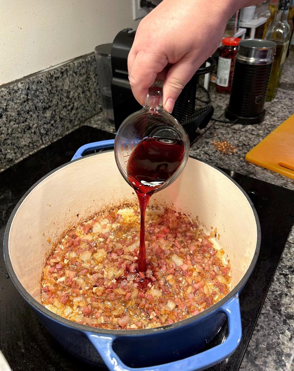 Adding the red wine for Ina Garten's weeknight pasta