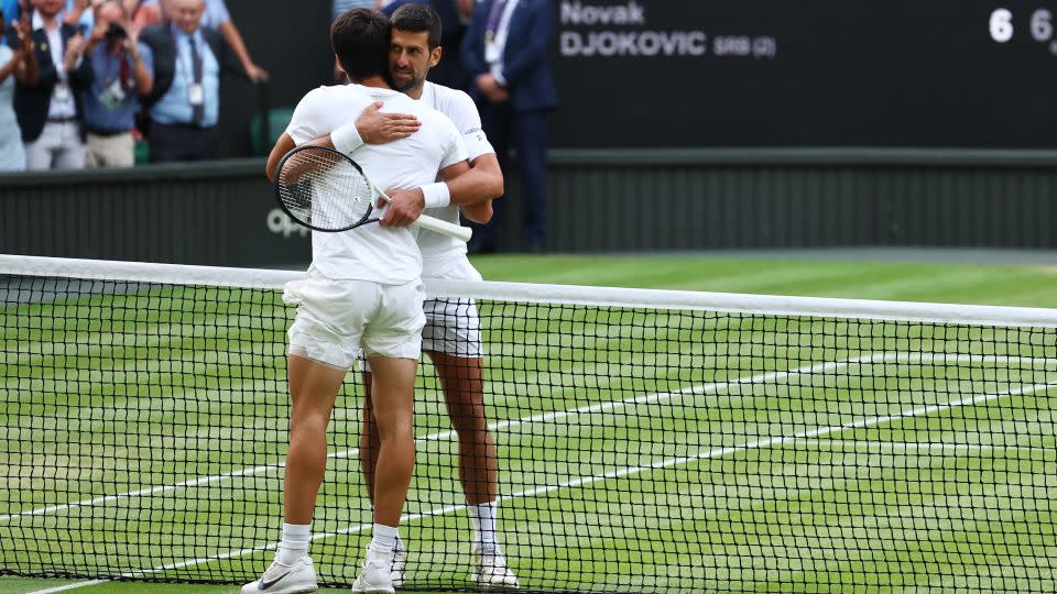 Alcaraz and Djokovic embrace at the net. - Toby Melville/Reuters