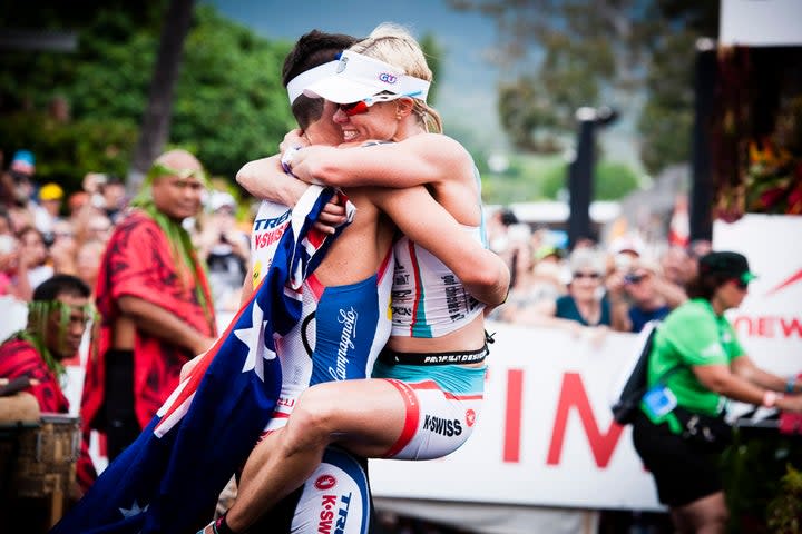 Mirinda Carfrae and Tim O’Donnell embrace at the finish line of the 2013 Ironman World Championship. Photo: John David Becker