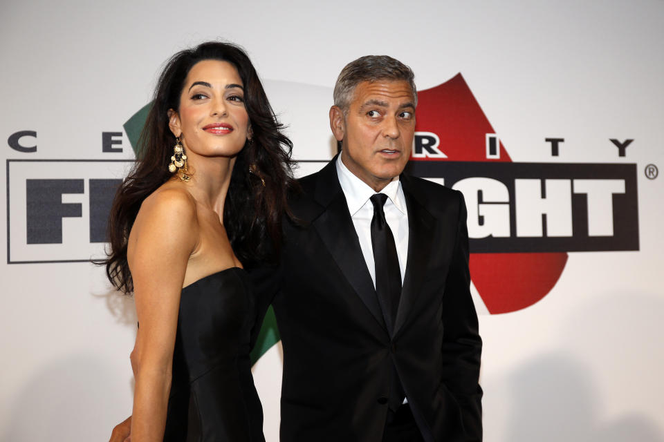 Director and actor George Clooney arrives with his fiancee barrister Amal Alamuddin to attend the Celebrity Fight Night event in Florence September 7, 2014. REUTERS/Giampiero Sposito (ITALY - Tags: ENTERTAINMENT)