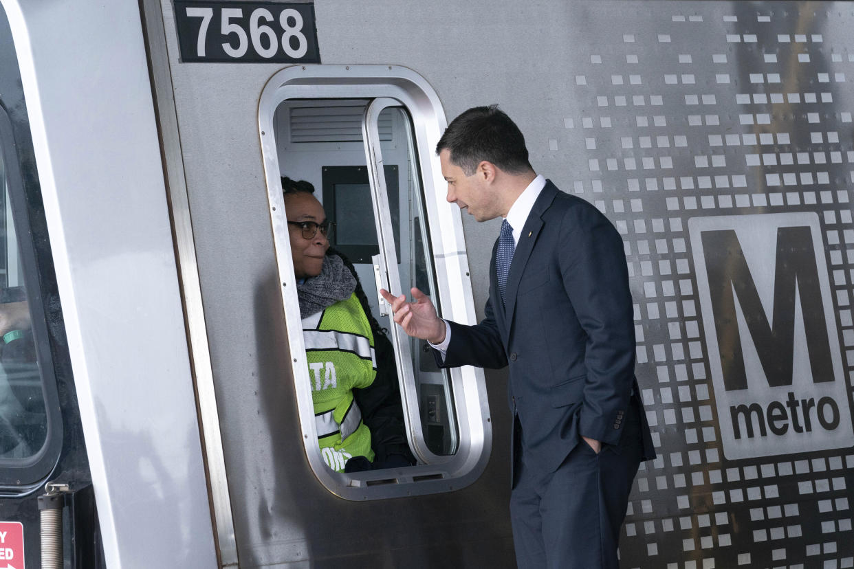 FILE - Transportation Secretary Pete Buttigieg, speaks to a metro worker during the opening of new Silver Line Extension at Washington Dulles International Airport, in Chantilly, Va., on Nov. 15, 2022. (AP Photo/Jose Luis Magana, File)