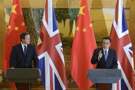 Britain's Prime Minister David Cameron (L) listens to China's Premier Li Keqiang as the two leaders deliver statements following a signing ceremony at the Great Hall of the People in Beijing December 2, 2013. REUTERS/Ed Jones/Pool