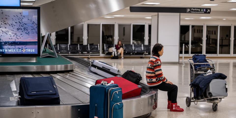 A traveler sits on the baggage claim carousel at George Bush Intercontinental Airport on December 27, 2022 in Houston, Texas.