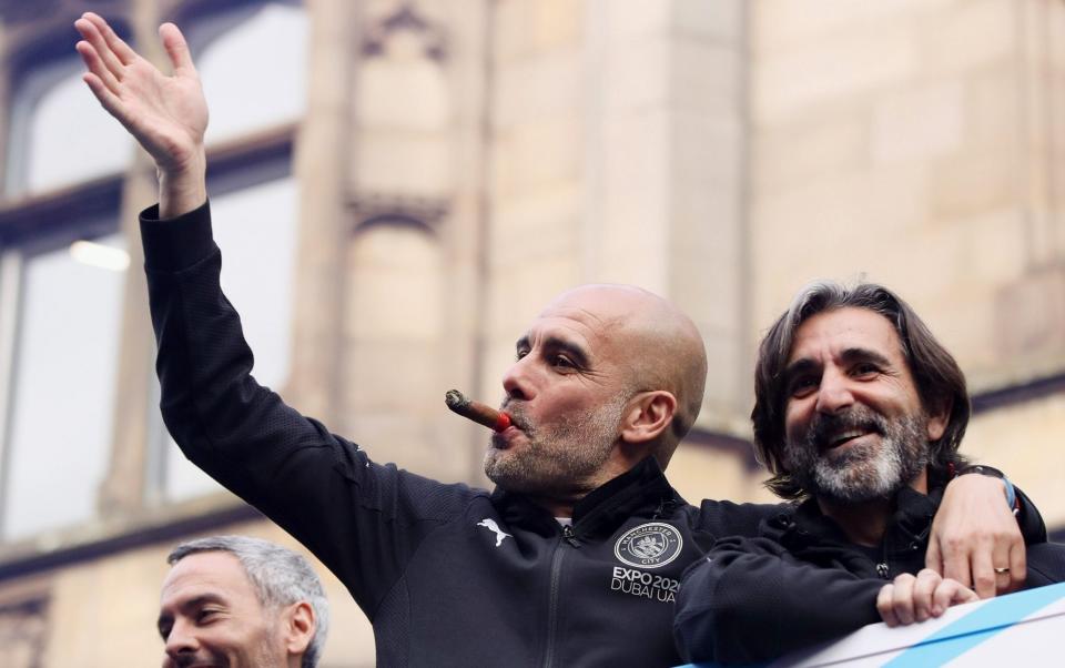 Pep Guardiola, Manager of Manchester City celebrates with staff on the parade bus during the Manchester City FC Victory Parade on May 23, 2022 in Manchester, England. - GETTY IMAGES