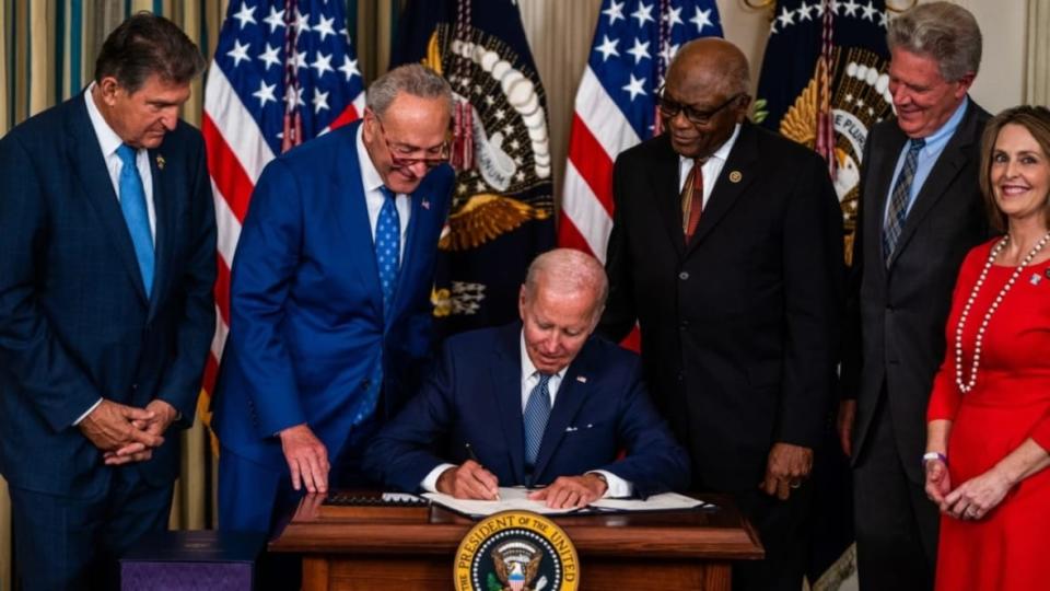 President Joe Biden (seated) signs into law H.R. 5376, the Inflation Reduction Act of 2022, the climate change and health care bill, in the State Dining Room of the White House with (from left) Democratic Sen. Joe Manchin of West Virginia, Senate Majority Leader Chuck Schumer of New York, House Majority Whip Rep. James Clyburn of South Carolina, Democratic Rep. Frank Pallone of New Jersey and Democratic Rep. Kathy Castor of Florida. Speaker Chris Welch of Illinois said this week that the act will have “positive effects for years to come. (Photo: Demetrius Freeman/The Washington Post via Getty Images)