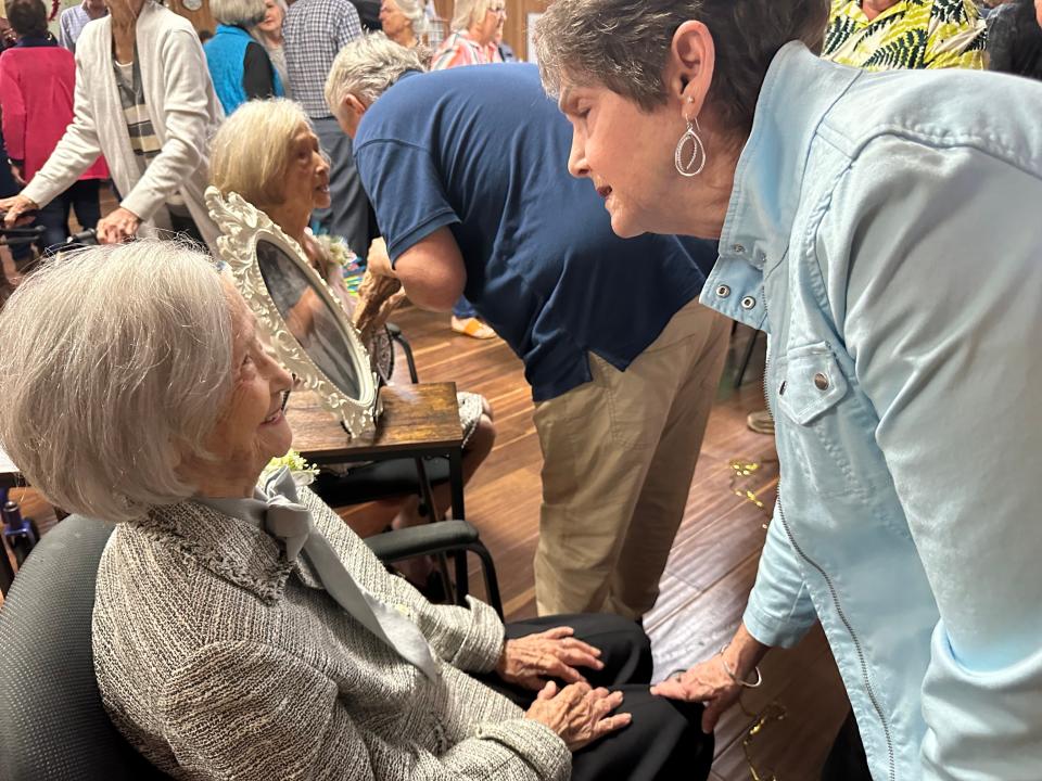 Lewana Patterson talks with Era Herring Luckie Daniell as she goes through the line at the birthday celebration.