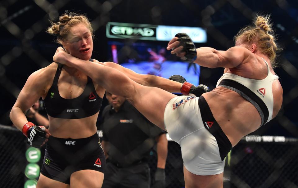 Holly Holm of the US (R) lands a kick to the neck to knock out compatriot Ronda Rousey and win the UFC title fight in Melbourne on November 15, 2015.   RESTRICTED TO EDITORIAL USE NO ADVERTISING USE NO PROMOTIONAL USE NO MERCHANDISING USE.  AFP PHOTO/Paul CROCK        (Photo credit should read PAUL CROCK/AFP/Getty Images)