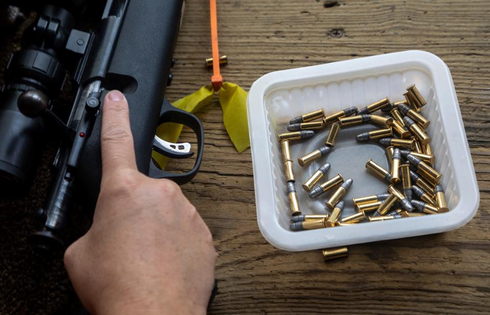 A student places their rifle on a wooden table during the Hunter Safety Field Day at the Washtenaw Sportsman's Club in Ypsilanti on Saturday, Sept. 9, 2023.