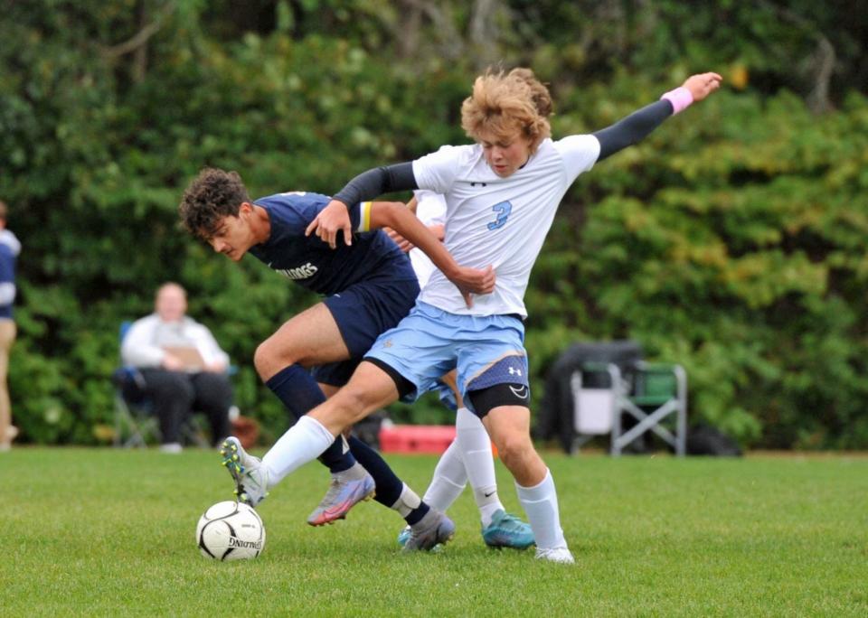 Rockland's Joao Faria, left, tries to get control of the ball from East Bridgewater's Jackson Rix, right, during boys soccer at Rockland High School, Monday, Oct. 3, 2022.