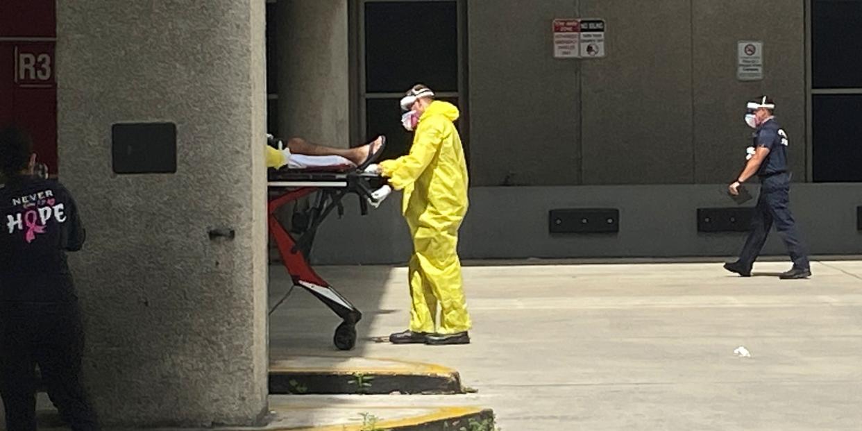 FILE PHOTO: A patient is brought to Jackson Health Center by paramedics wearing protective clothing due to the threat of coronavirus disease (COVID-19) in Miami, Florida, U.S. July 13, 2020. REUTERS/Liza Feria