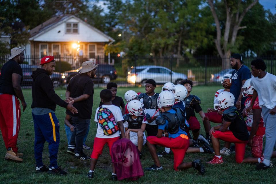 Members of the West Side Cubs 14U football team listen to coaches at the end of practice at McCabe Field in Detroit on Tuesday, September 12, 2023. More than just youth football and cheerleading teams, the West Side Cubs represent a vital community institution with a 66-year history.