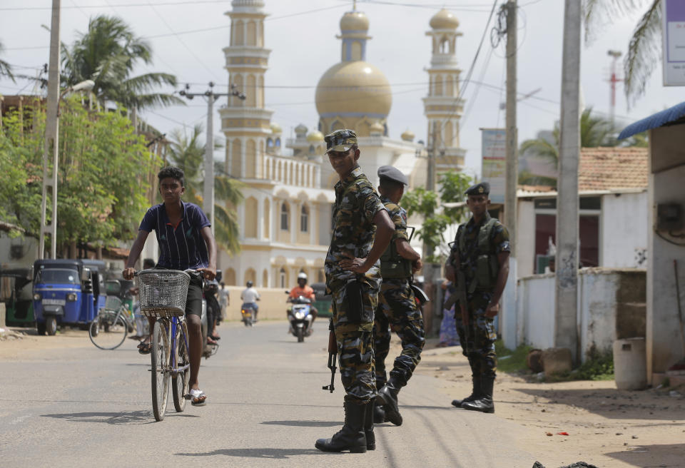 Sri Lankan air force soldiers secure a Muslim neighborhood following an overnight clash in Poruthota, a village in Negombo, about 35 kilometers North of Colombo, Sri Lanka, Monday, May 6, 2019. Two people have been arrested and an overnight curfew lifted Monday after mobs attacked Muslim-owned shops and some vehicles in a Sri Lankan town where a suicide bombing targeted a Catholic church last month. Residents in the seaside town of Negombo say the mostly-Catholic attackers stoned and vandalized shops. It is unclear how the dispute began but most residents say a private dispute took a religious turn. (AP Photo/Eranga Jayawardena)