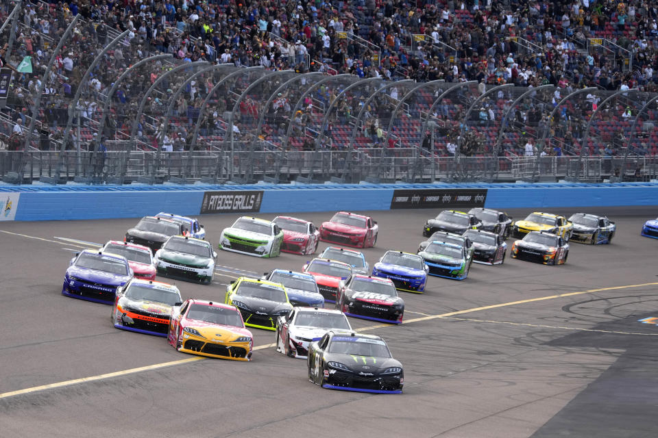 Ty Gibbs (54) leads the field on the first lap during the NASCAR Xfinity Series auto race Saturday, Nov. 5, 2022, in Avondale, Ariz. (AP Photo/Rick Scuteri)