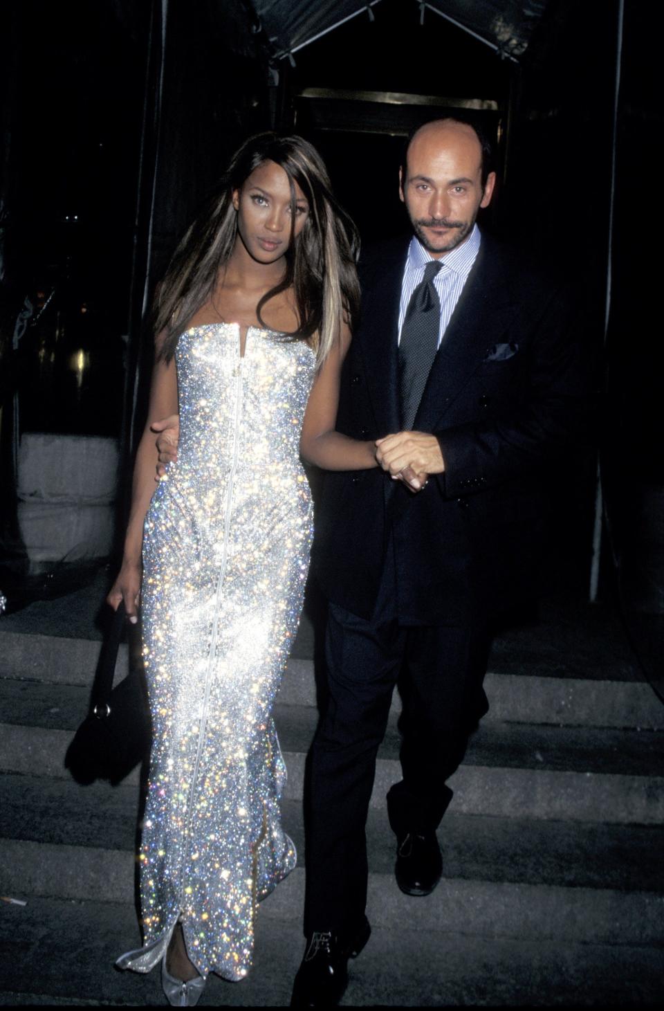 Naomi Campbell attends the 1995 Met Gala in a shimmering silver gown.