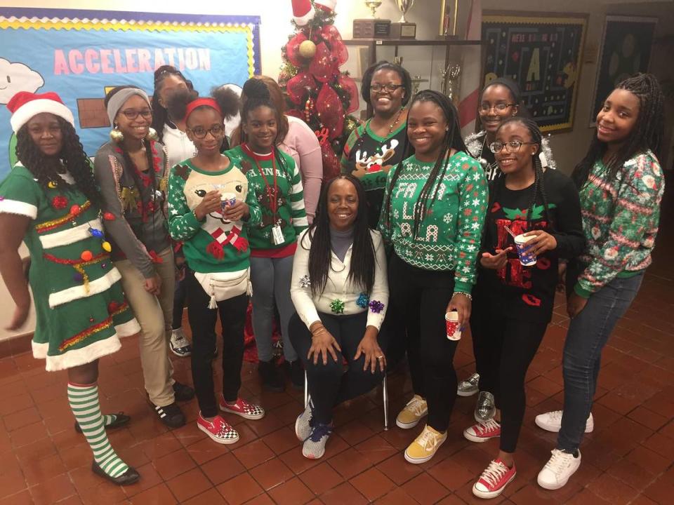 Members of Girl Scout Troop 347 proudly display their sweaters in Ugly Holiday Sweater contest.