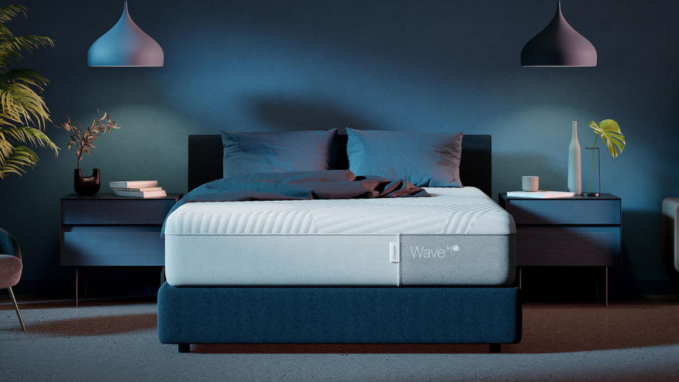 Casper Wave Hybrid Snow review: mattress in the centre of a bedroom with plants on either side