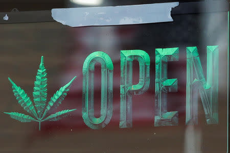 An 'Open' sign is displayed on the door of Dorothy Stepnowska's Flower Power Coffee House, a CBD cafe, in the Queens borough of New York City, U.S., March 6, 2019. Picture taken March 6, 2019. REUTERS/Brendan McDermid