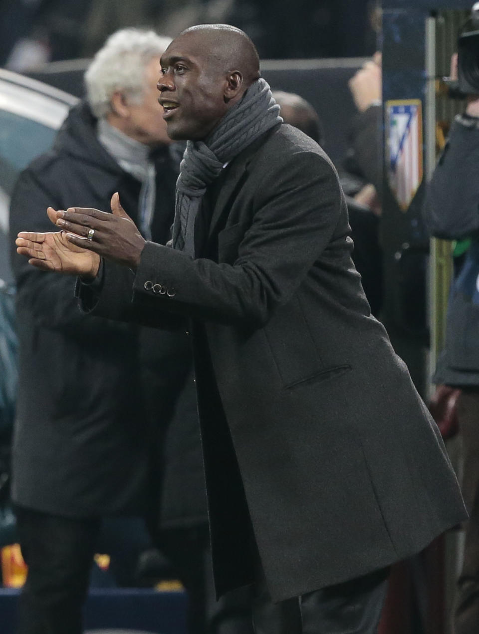 AC Milan's coach Clarence Seedorf urges his players during a round of 16th Champions League soccer match between AC Milan and Atletico Madrid at the San Siro stadium in Milan, Italy, Wednesday, Feb. 19, 2014. (AP Photo/Emilio Andreoli)