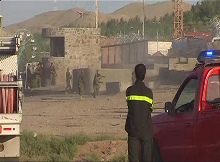 Afghan soldiers take up positions outside the U.S. Consulate after an attack by insurgents in the western Afghanistan city of Herat, in this still image taken from video on September 13, 2013. REUTERS/Reuters TV