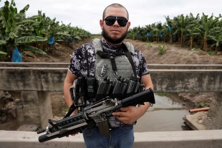 A vigilante poses for a photo while patrolling the municipality of Coahuayana