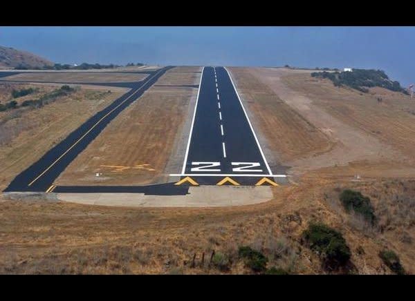 Catalina Airport (nicknamed "Airport in the Sky" due to its high elevation) is known to have downdrafts and turbulence on approach. Its runway drops off on both sides and is so raised in the middle that pilots on one end can't see the other. Heavy rains often litter it with pieces of asphalt, potholes and soft spots.    (Photo: Courtesy Bob Rhein, Catalina Island Conservancy)