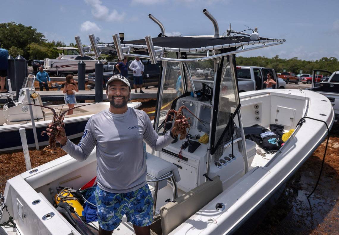 Pembroke Pines resident Santiago Figueroa, 31, a biochemical engineer, holds two lobsters his crew caught as he and other boaters returned to Matheson Hammock Marina with their catch. The 48-hour miniseason for Florida’s spiny lobster opened Wednesday, July 27, 2022 as S. Floridians headed out to take advantage of the abbreviated annual event along the Sunshine State’s coastline.