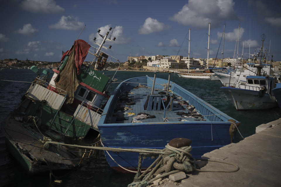 Empty boats used by migrants to cross the Mediterranean Sea from Libya to Italy are tied to the docks on the island of Lampedusa, Italy, Thursday, Sept. 30, 2021. Despite the risks, many migrants and refugees say they'd rather die trying to cross to Europe than be returned to Libya where, upon disembarkation, they are placed in detention centers and often subjected to relentless abuse. (AP Photo/Renata Brito)