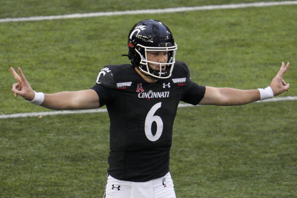 After playing last season as Cincinnati's starting quarterback Ben Bryant is transferring to Northwestern for his final year of eligibility. (AP Photo/Jeff Dean)