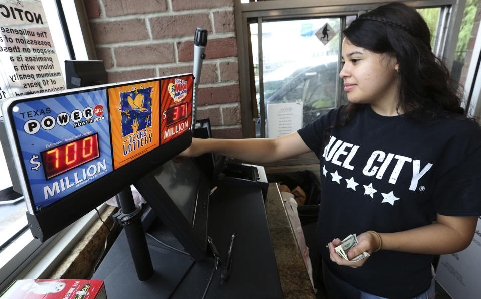 <p>Anahi Medrano sells a Powerball lottery ticket at a convenience store in Dallas, Aug. 23, 2017. Lottery officials said the grand prize for Wednesday night’s drawing has reached $700 million. The second -largest on record for any U.S. lottery game. (Photo: LM Otero/AP) </p>