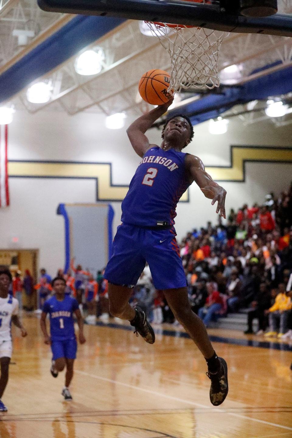 Johnson High's Antonio Baker breaks away for a dunk against Beach High on Friday January 6, 2023.